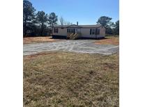 Charming single story home with gravel driveway and inviting front porch and dark shutters at 8183 Hallman Mill Rd, Vale, NC 28168