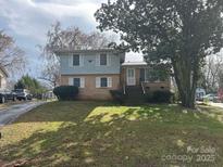 Charming two-story home with brick and siding exterior and well-maintained front yard at 8313 Lamplighter Pl, Charlotte, NC 28217