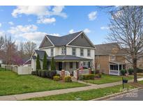 Inviting two-story home with manicured lawn, covered porch, and gray architectural shingles at 10011 Roosevelt Dr, Huntersville, NC 28078