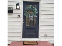 Charming front door with welcome wreath and black-and-white striped bow detail at 1003 Woodland Dr, Gastonia, NC 28054