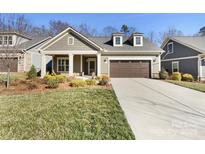 Charming one-story home featuring a manicured lawn and a two-car garage, perfect for comfortable living at 1063 Millview Ln, Matthews, NC 28104