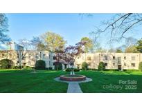 Apartment complex with well-manicured lawn and colorful trees in a park-like setting at 1121 Myrtle Ave # 17, Charlotte, NC 28203
