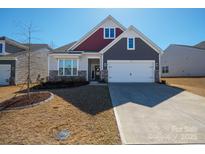 Charming two-story home featuring a well-manicured lawn and an attached two-car garage at 168 Kennerly Center Dr, Mooresville, NC 28115