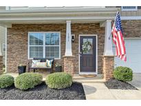 Charming front porch with stone accents, decorative wreath and a bench, offering a warm, inviting welcome at 181 Atwater Landing Dr, Mooresville, NC 28117