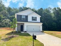 Charming two-story home featuring a mix of siding and stone accents, plus a two-car garage at 200 Lake George Dr, Shelby, NC 28152