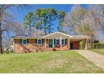 Charming single story home with a brick facade, green shutters, and a well-maintained front lawn at 2027 Franklin St, Rock Hill, SC 29732