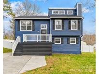 Charming blue two-story home with a welcoming front porch and well-maintained lawn at 220 King George Ln, Gastonia, NC 28056