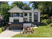 Attractive modern home with manicured lawn and a black garage door, creating a welcoming curb appeal at 3416 Windsor Dr, Charlotte, NC 28209