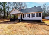 Charming exterior of a single-story home featuring a cozy front porch and classic architectural details at 4221 E Maiden Rd, Maiden, NC 28650