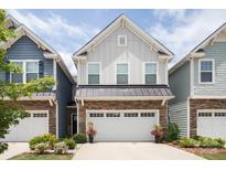 Charming two-story home with gray siding, stone accents, and a two-car garage at 7456 Hartsfield Dr, Lancaster, SC 29720