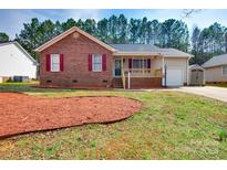 Charming home featuring a brick facade, vinyl siding, and a cozy front porch at 806 E Ridge St, Kings Mountain, NC 28086