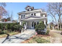 Charming two-story home with a covered front porch and well-maintained landscaping at 819 Sunnyside Ave, Charlotte, NC 28204