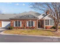Charming brick home with manicured lawn and tasteful landscaping at 8525 Kilty Ct, Charlotte, NC 28269
