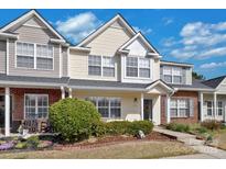 Charming townhouse with a well-maintained front yard and inviting entrance at 10934 Kinston Ridge Pl, Charlotte, NC 28273