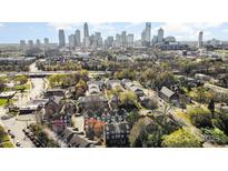 An aerial view showing the neighborhood and the city skyline in the background at 1525 Walnut View Dr, Charlotte, NC 28208