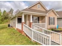 Inviting single-story home featuring a ramp, covered porch with white columns, and neutral siding at 163 Brookshire Dr, Fort Mill, SC 29715