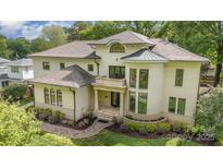 Stunning two-story home with landscaped front yard, elegant architectural details, and a welcoming entrance at 1665 Sterling Rd, Charlotte, NC 28209