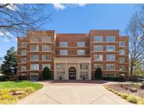 Beautiful brick building with elegant entrance and manicured landscaping offering a sophisticated living experience at 2445 Selwyn Ave, Charlotte, NC 28209