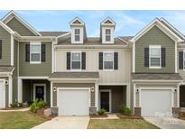 Charming townhome with attached garage, dormer windows, and modern color palette at 2749 Yeager Nw Dr, Concord, NC 28027