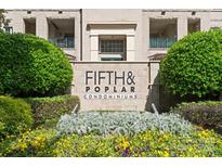 Fifth and Poplar Condominiums entrance featuring landscaping and classic architecture at 300 W 5Th St # 224, Charlotte, NC 28202