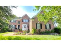 Lovely two-story brick home with a well-manicured lawn and beautiful landscaping at 3304 Taviston Dr, Waxhaw, NC 28173