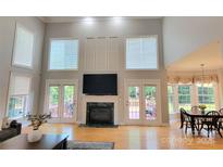 Bright living room features high ceilings, fireplace, and access to the outdoor deck at 3304 Taviston Dr, Waxhaw, NC 28173