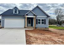 Charming new construction home featuring a blue exterior, attached garage and inviting front porch at 409 Bost St, Kannapolis, NC 28081