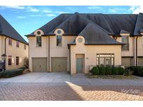 Elegant two-story home with a dual-car garage and appealing architectural details and well-maintained landscaping at 8812 Provence Village Ln, Charlotte, NC 28226