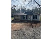 Charming single-story home with gray siding, black shutters and a covered carport at 112 S Hill Ave, Albemarle, NC 28001