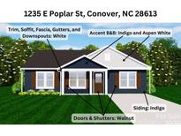 Charming single-Gathering home featuring indigo siding, walnut doors and shutters, and green landscaping at 1235 E Poplar St, Conover, NC 28613