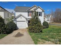 Charming two-story home with landscaped yard and driveway at 1421 Braveheart Ln, Charlotte, NC 28216