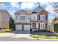 Charming two-story home with a two-car garage, manicured lawn, and a combination of siding and stone accents at 1857 Felts Pkwy, Fort Mill, SC 29715