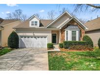 Charming home with a two-car garage, stone accents, and well-maintained landscaping at 3104 Streamhaven Dr, Indian Land, SC 29707
