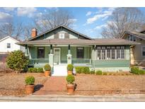 Charming craftsman-style home with a brick walkway leading to a cozy covered front porch at 36 Yorktown Nw St, Concord, NC 28025