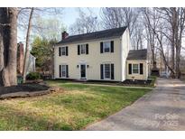 Charming two-story home with manicured lawn, dark shutters, and inviting front entrance at 9709 Cloverwood Ct, Charlotte, NC 28270