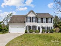 Charming two-story home with black shutters and an attached two-car garage on a well-manicured lawn at 1102 Balcorn Pl, Charlotte, NC 28214