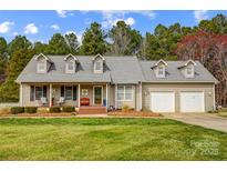 Charming single-Gathering home featuring a well-manicured lawn, attached two-car garage, and a welcoming covered front porch at 1625 Saint Paul Church Rd, Salisbury, NC 28146