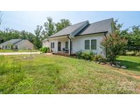 Charming single-story home featuring a well-maintained lawn and a cozy front porch with chairs at 1700 Ivey Ct, Maiden, NC 28650