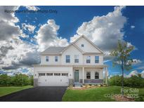 Charming two-story home with a two-car garage, manicured lawn, and lovely landscaping at 2009 Nettle Bank Rd # 3292, Indian Trail, NC 28079