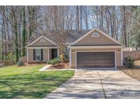 Charming single-Gathering home featuring an attached garage, well-maintained lawn, and inviting curb appeal at 201 Remally Ln, Huntersville, NC 28078