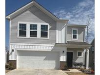 Charming two-story home boasts a two-car garage, neat landscaping, and neutral siding at 202 Brentwood Dr, Statesville, NC 28625