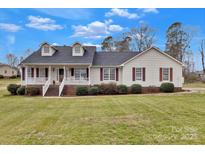 Charming home featuring a well-manicured lawn, inviting porch, and classic architectural details at 207 Silver Creek Ln, Shelby, NC 28152
