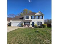 Charming two-story home with a well-manicured lawn, attached garage, and classic suburban appeal at 4210 Runaway Cir, Monroe, NC 28110