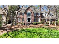 Classic brick home with manicured lawn and lush landscaping showcases elegant curb appeal at 5114 Morrowick Rd, Charlotte, NC 28226