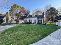 Charming home with a manicured lawn, lovely landscaping, and inviting curb appeal, making it a delightful residence at 7327 Carrbridge Ln, Charlotte, NC 28226