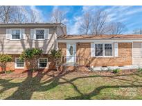 Charming brick home featuring a welcoming front entrance with decorative door and manicured landscaping at 809 E 23Rd Street St, Newton, NC 28658