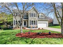 Charming two-story home with a well-manicured lawn, beautiful landscaping, and a two-car garage at 8511 Fox Tail Ln, Huntersville, NC 28078