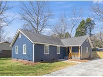 Charming blue home featuring a quaint front porch and well-maintained lawn at 9930 Sardis Oaks Rd, Charlotte, NC 28270