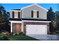 Two-story home featuring brick and light green siding with a two-car garage and a well-manicured lawn at 1466 31St Ne St, Conover, NC 28613