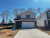 Charming two-story home featuring a gray color scheme, a two-car garage, and manicured landscaping at 1466 31St Ne St, Conover, NC 28613